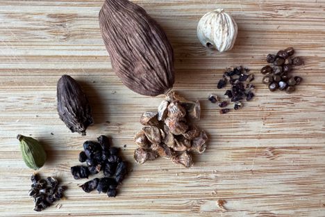 Left to right: green, black, Chinese, white, and Ethiopian cardamoms.